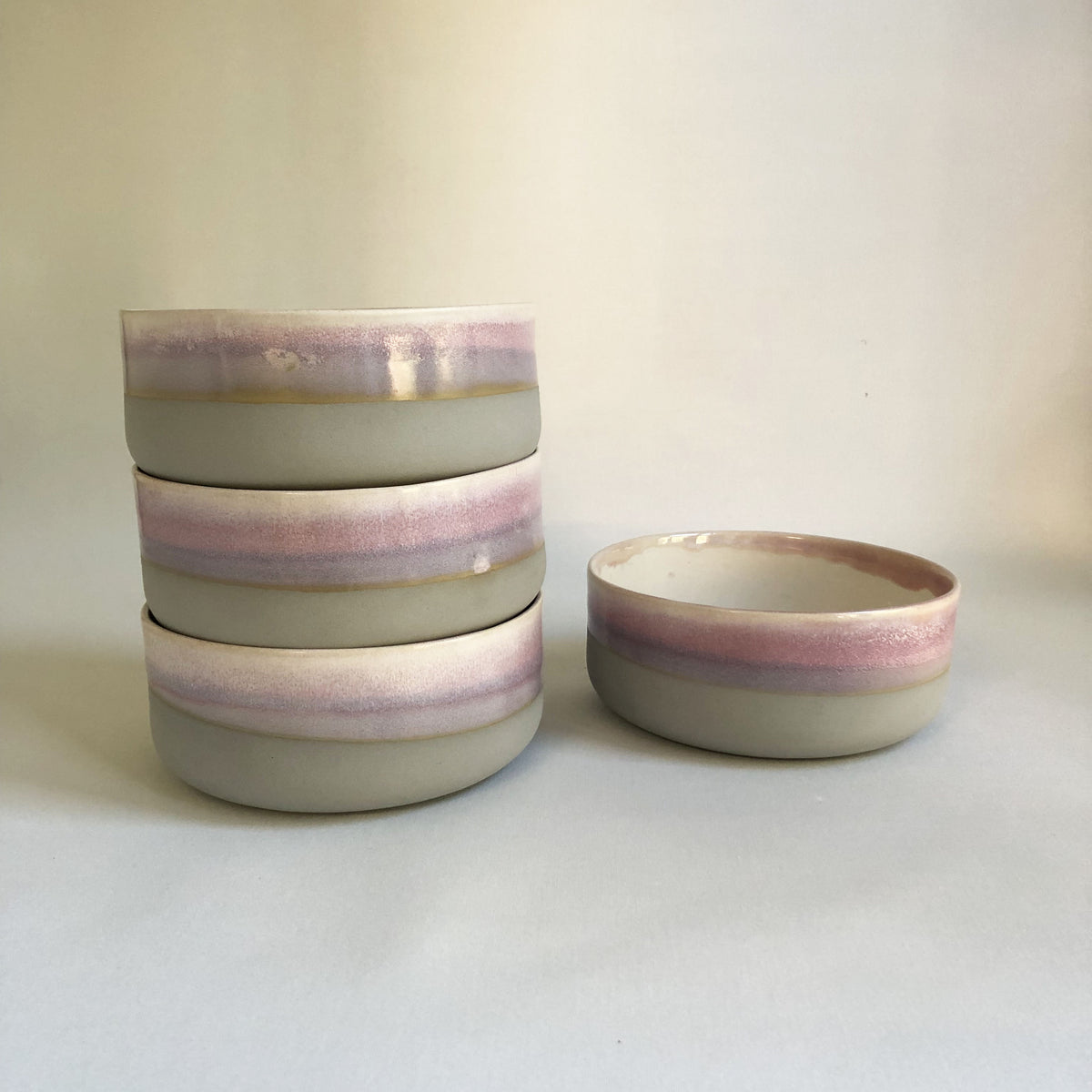Large bowl with matte light grey base and light pink glaze