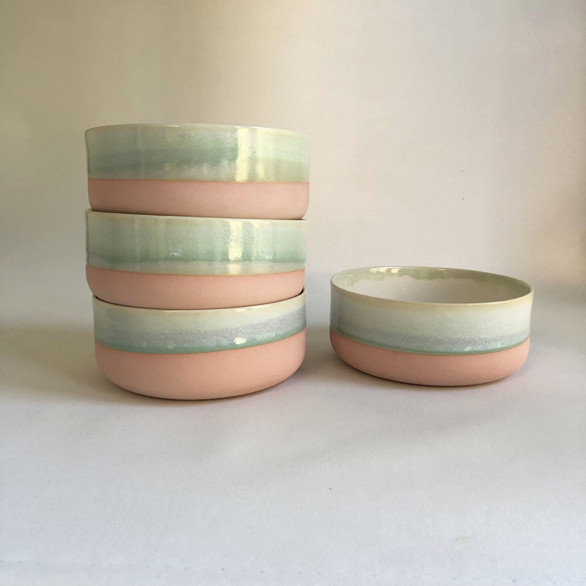 Large bowl with light pink bottom and green glaze