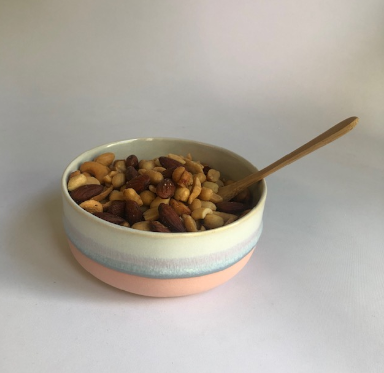 Small bowl with matte pink base and ice blue glaze