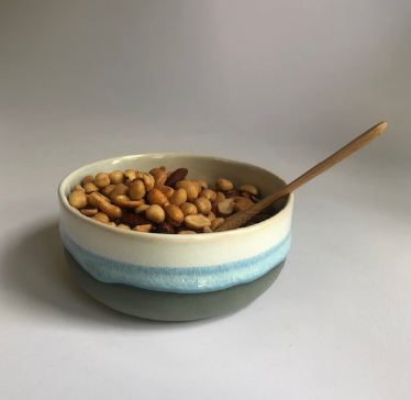 Small bowl with a matte dark grey base and ice-blue glaze
