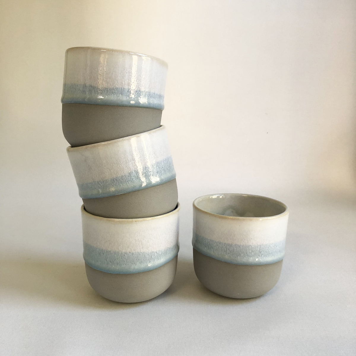 Large cup without a handle with a matte grey bottom and ice-blue glaze