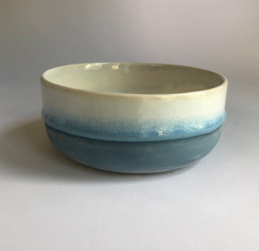 Small bowl with a matte dark blue base and ice blue glaze