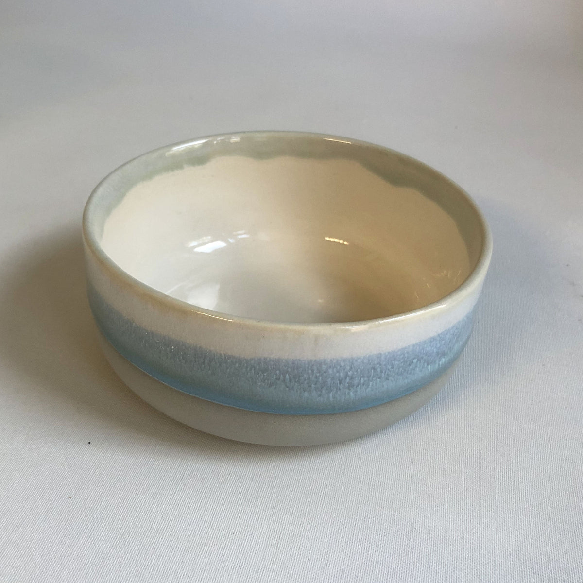 Small bowl with matte grey bottom and ice-blue glaze