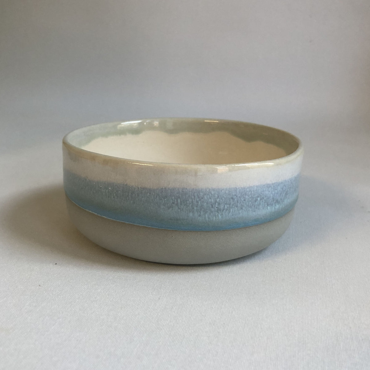Small bowl with matte grey bottom and ice-blue glaze