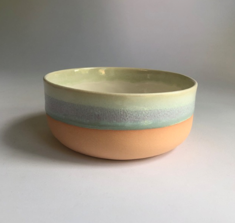 Small bowl with a matte coral-colored base and green glaze