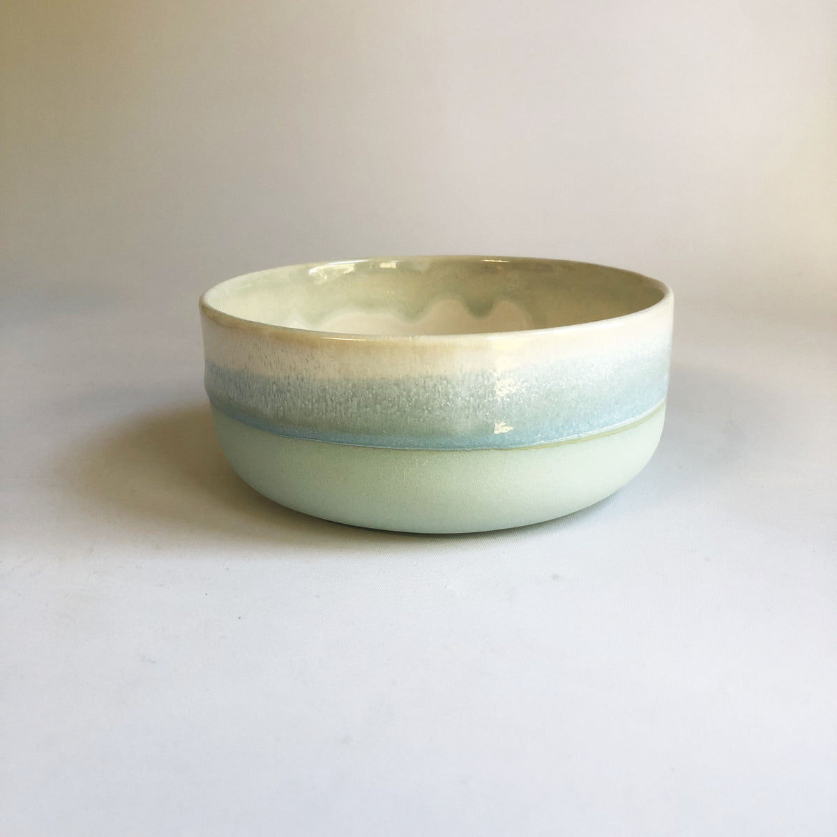 Small bowl with a matte light blue base and ice blue glaze