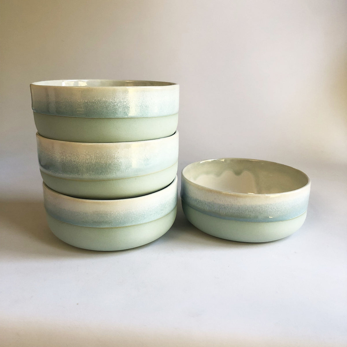 Small bowl with a matte light blue base and ice blue glaze