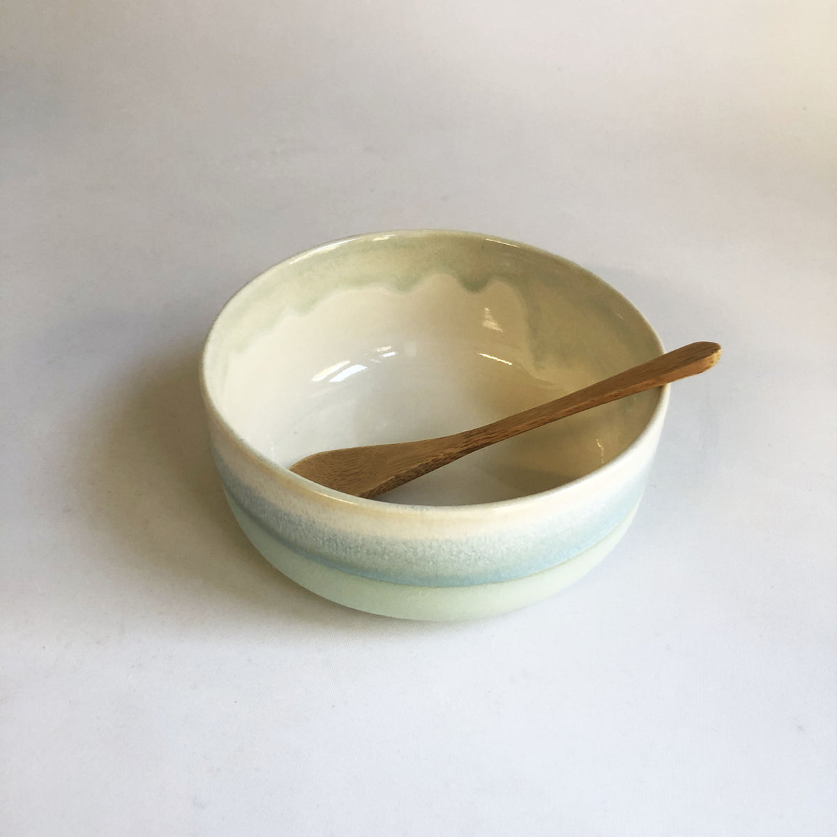 Small bowl with a matte light blue base and ice blue glaze