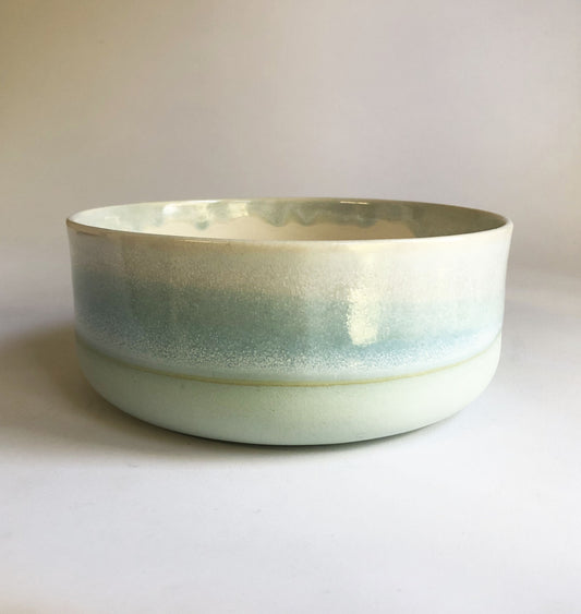 Large bowl with a matte blue base and ice-blue glaze