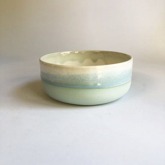 Small bowl with a matte light blue base and ice blue glaze