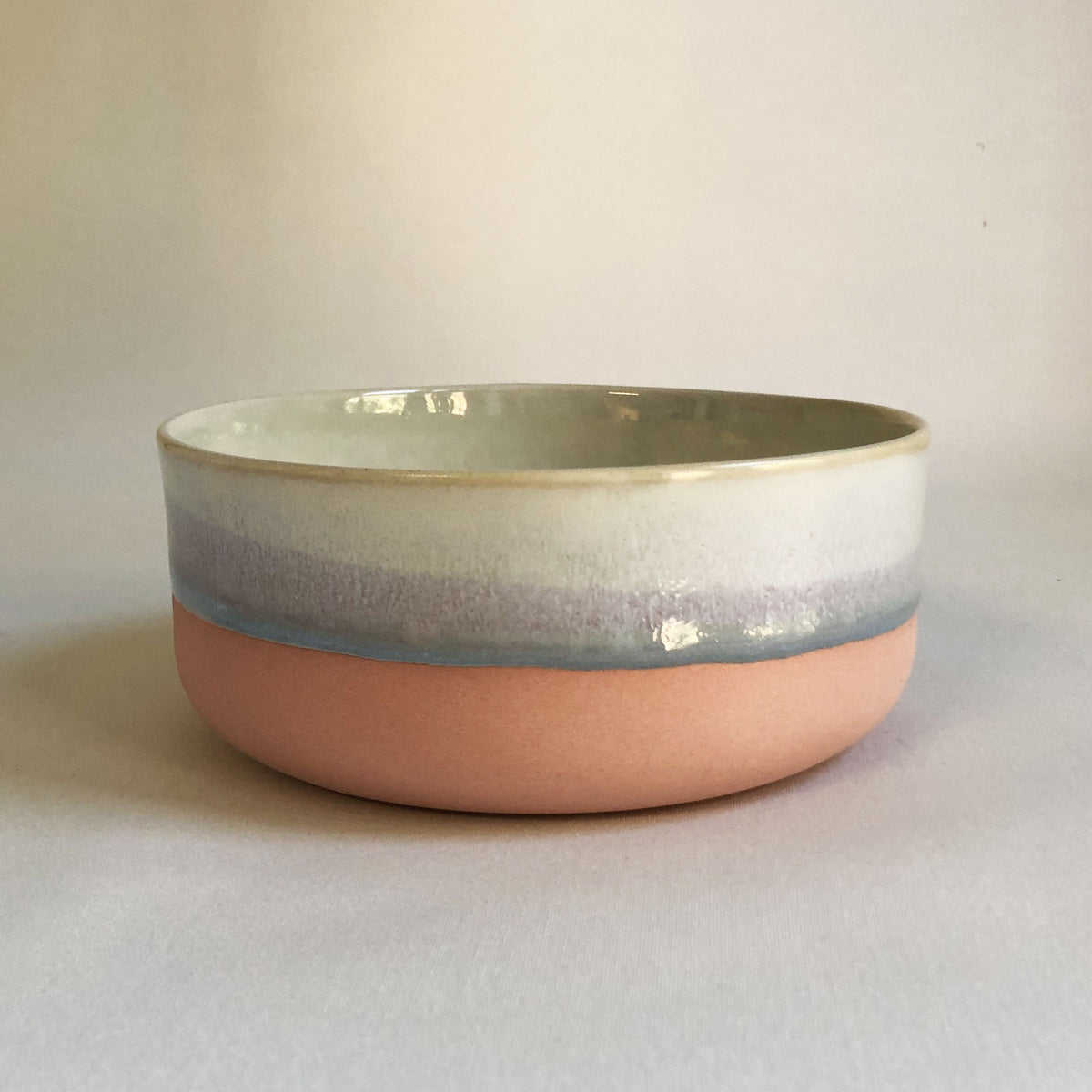 Large bowl with a matte pink bottom and ice blue glaze