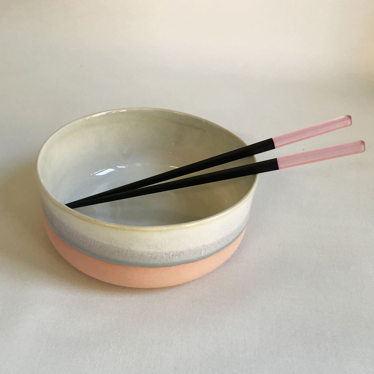 Large bowl with a matte pink bottom and ice blue glaze