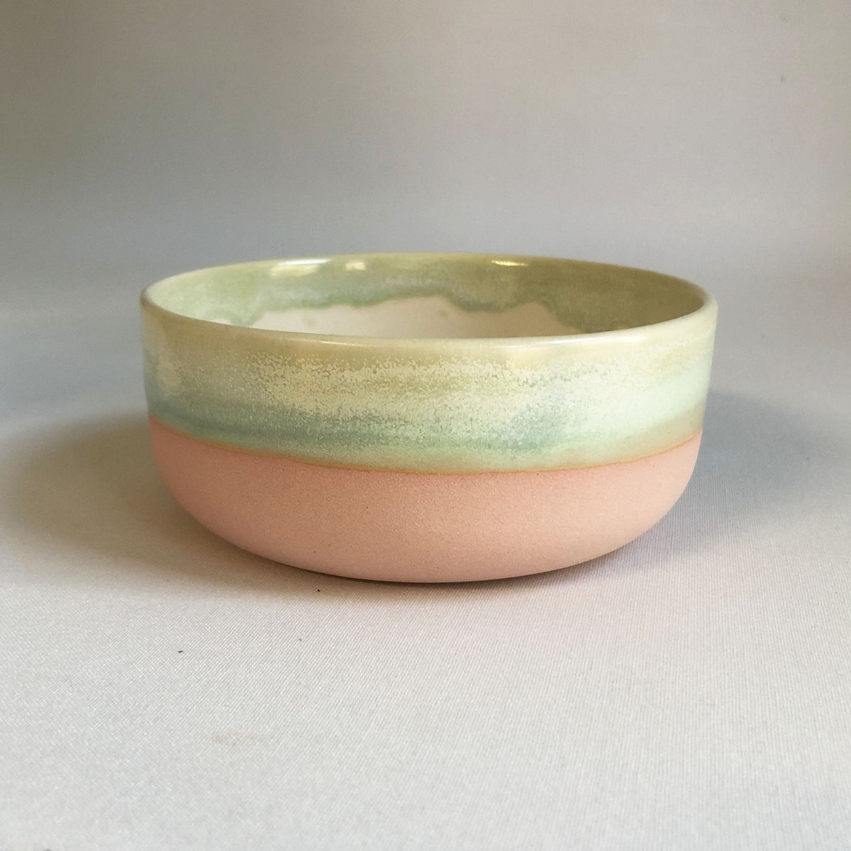 Small bowl with a matte pink bottom and green glaze