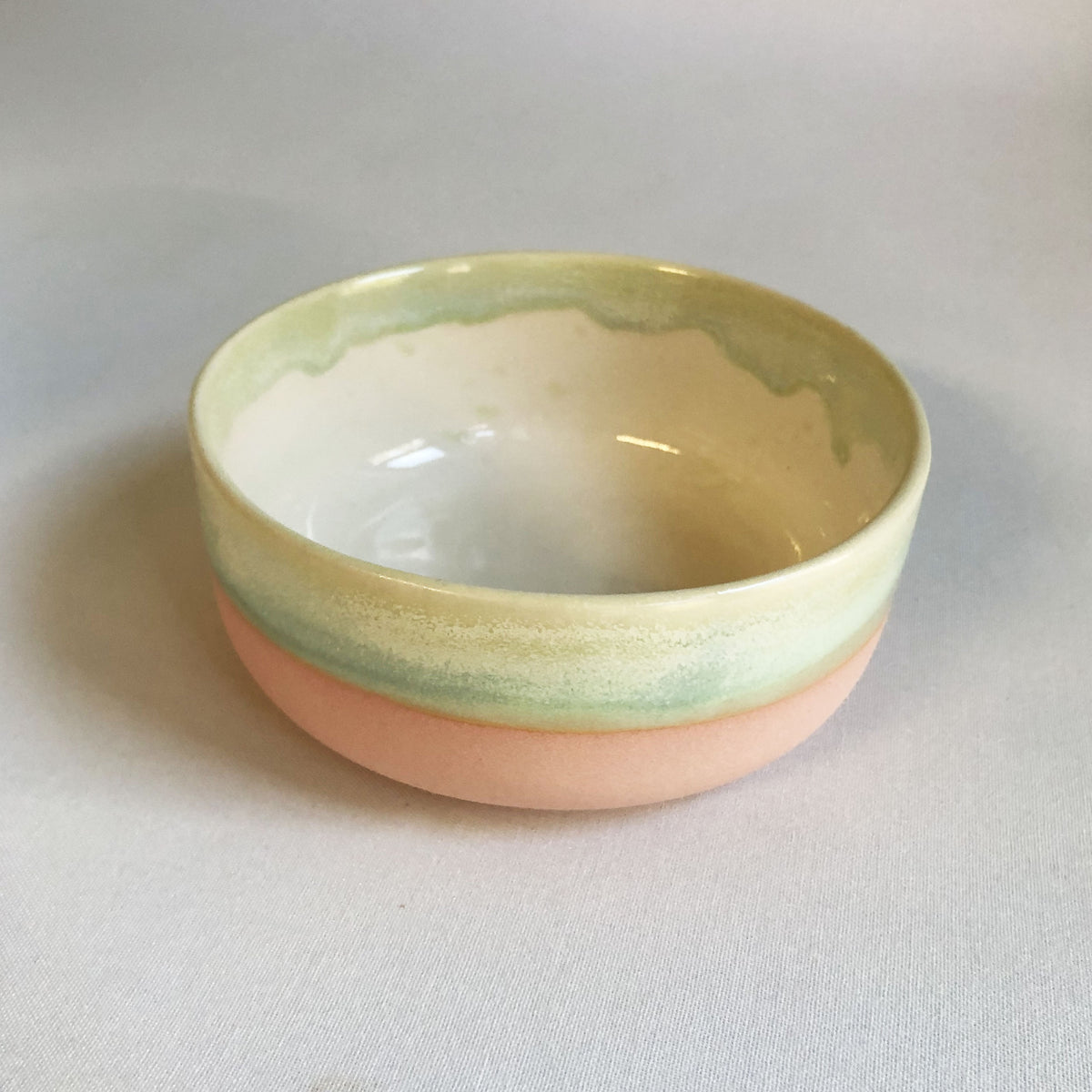 Small bowl with a matte pink bottom and green glaze
