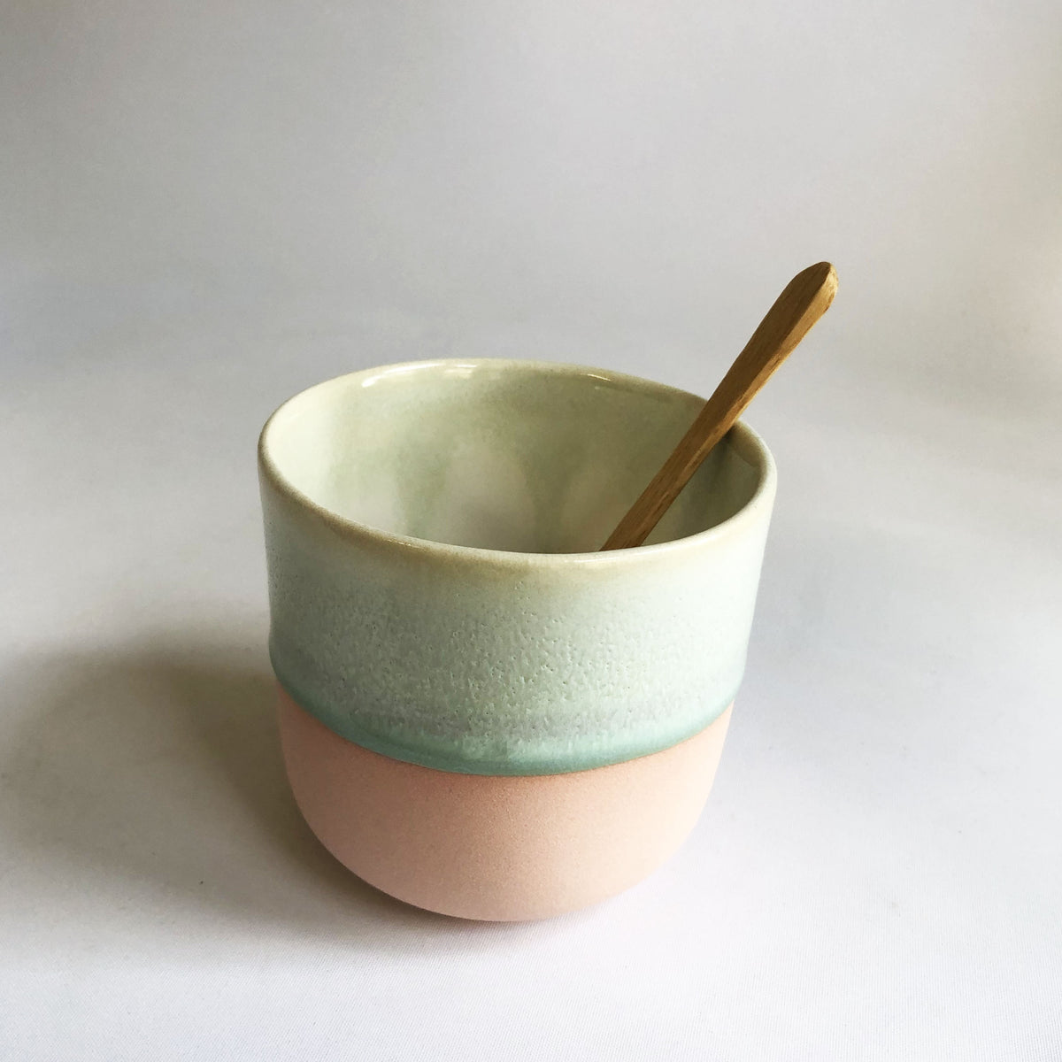 Large cup without handle with a matte light pink base and green glaze