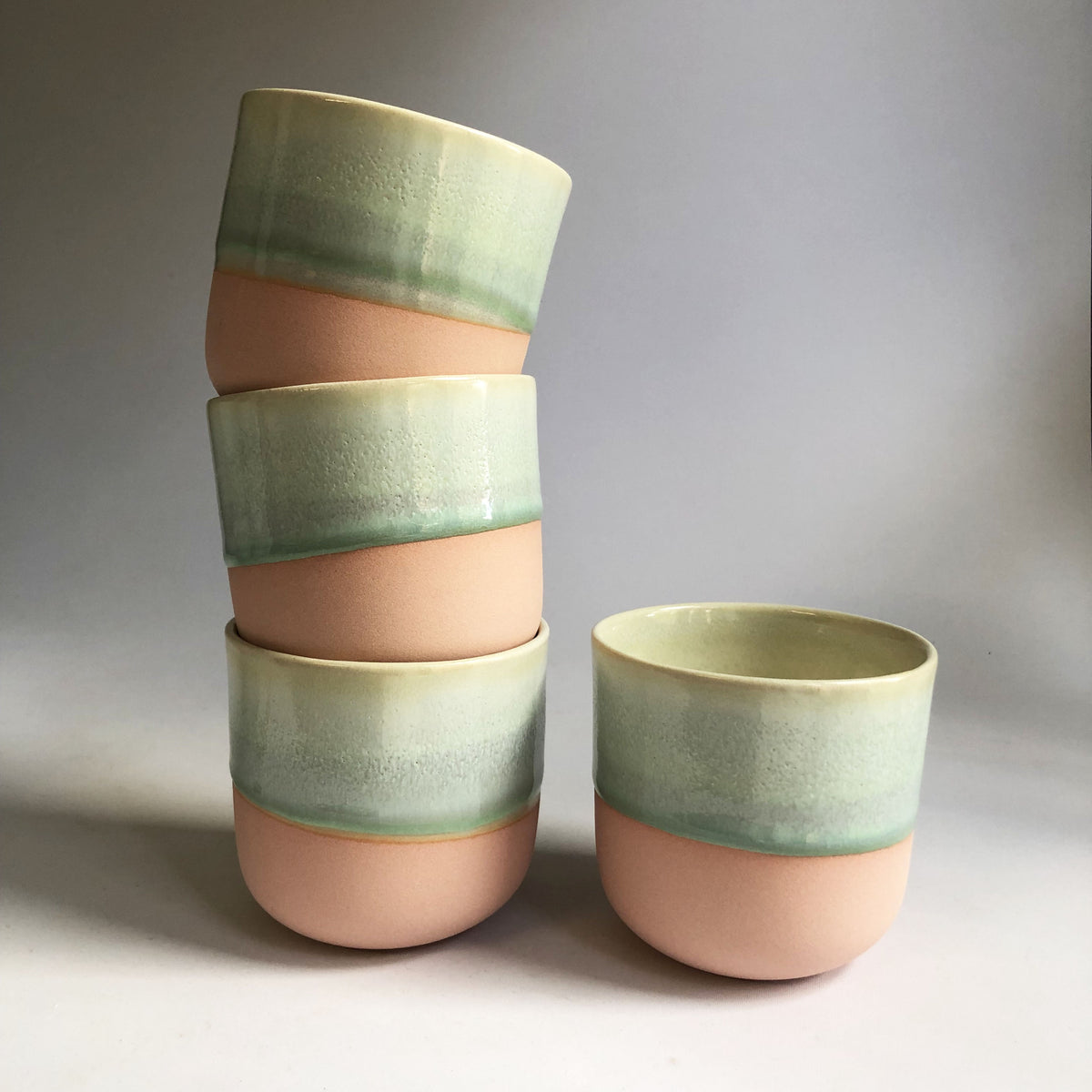 Large cup without handle with a matte light pink base and green glaze