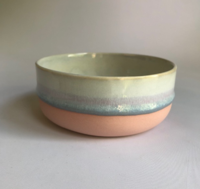 Small bowl with matte pink base and ice blue glaze