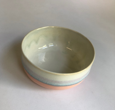 Small bowl with matte pink base and ice blue glaze