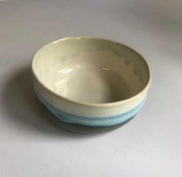Small bowl with a matte dark grey base and ice-blue glaze