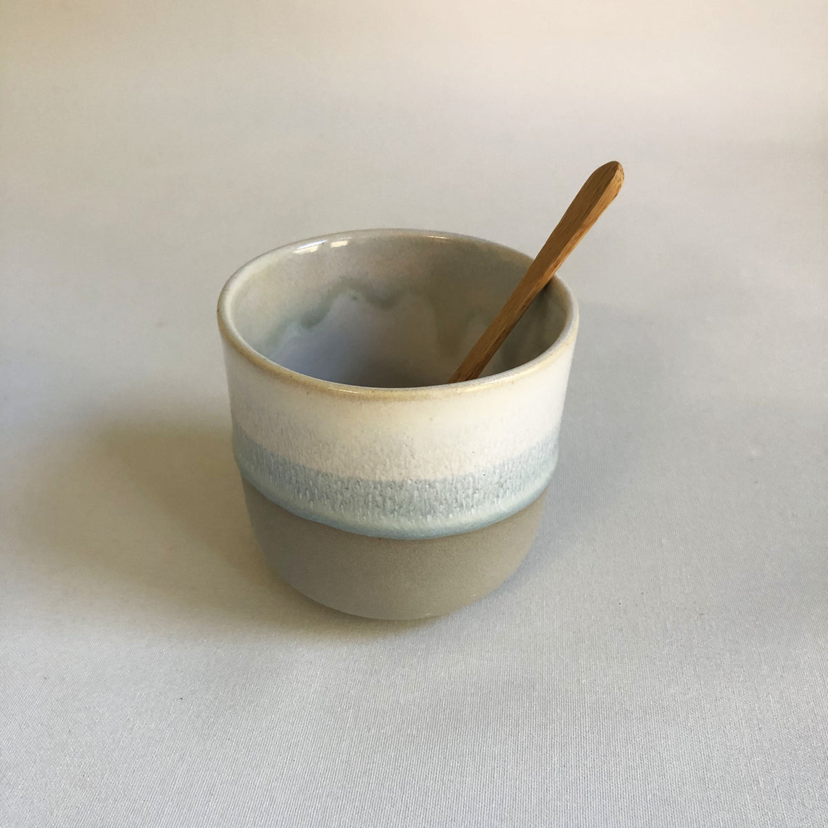 Large cup without a handle with a matte grey bottom and ice-blue glaze